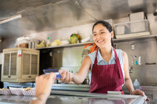 A worker working inside a food truck.