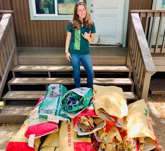 Ranch manager standing in front of recycled feed bags.